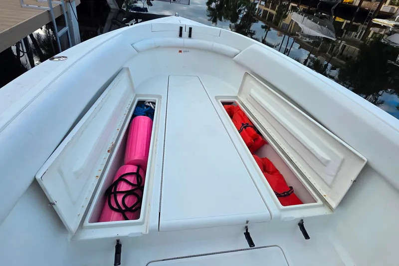 Slide: The Image of 1999 Hydra-Sports 3000 CC boat deck with open storage compartments and safety gear. - 18