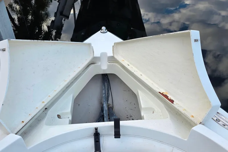 Slide: The Image of Open storage compartment on a 1999 Hydra-Sports 3000 CC boat, showing anchor and rope. - 19