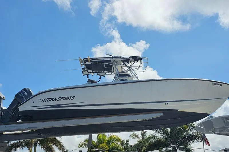 Slide: The Image of 1999 Hydra-Sports 3000 CC boat on display, clear sky background. - 2