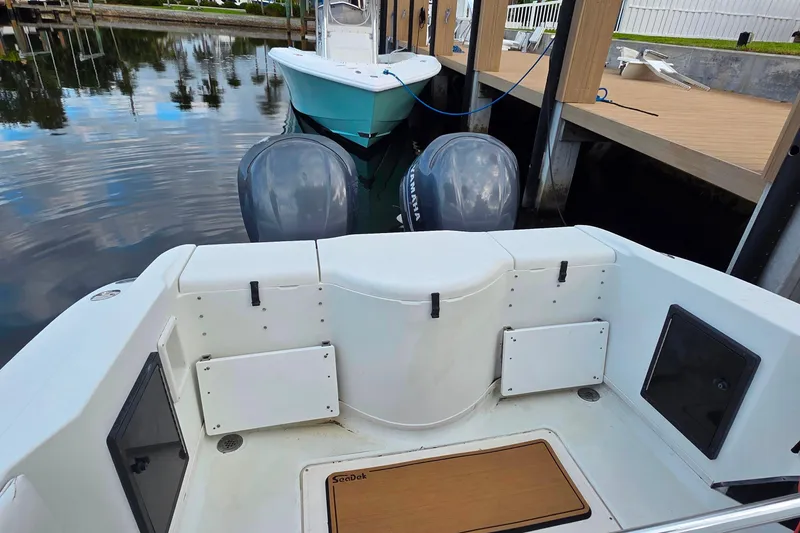 Slide: The Image of 1999 Hydra-Sports 3000 CC boat docked, featuring dual Yamaha outboard motors. - 6