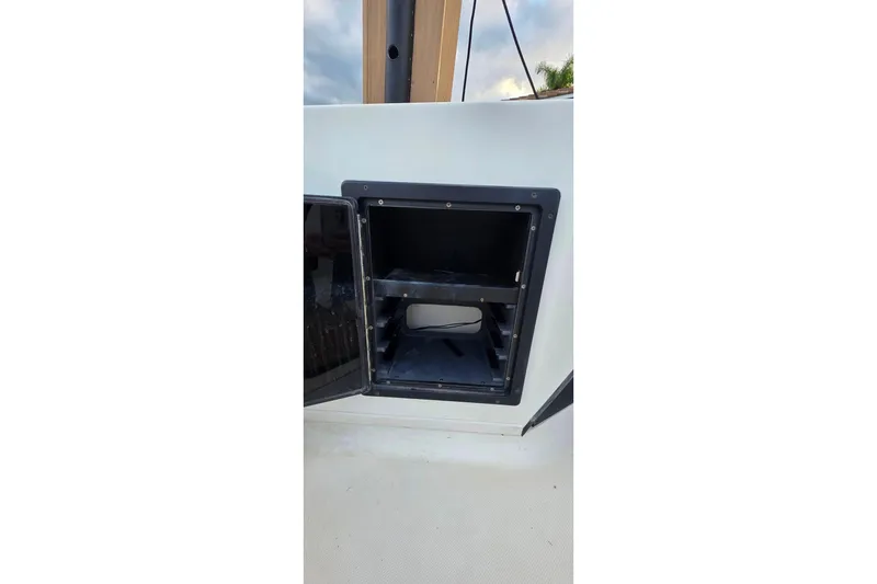 Slide: The Image of Open storage compartment on a 1999 Hydra-Sports 3000 CC boat. - 7