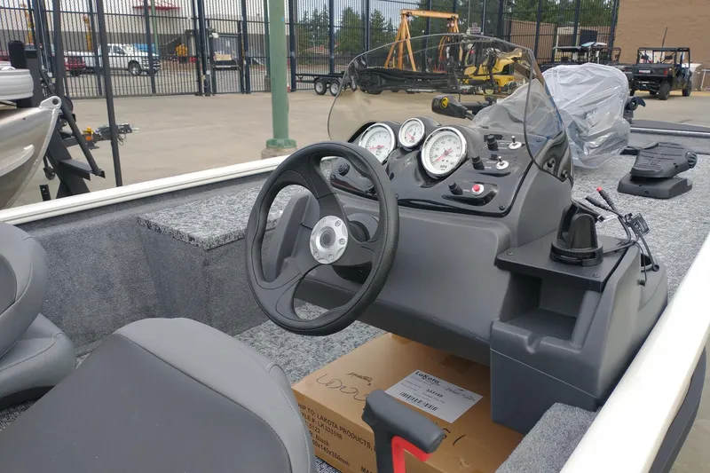 Slide: The Image of 2026 Tracker Pro 170 boat interior with steering wheel and dashboard gauges. - 3