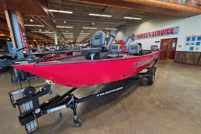 Slide: The Image of 2026 Tracker Pro Guide V-16 SC boat displayed in showroom, vibrant red color. - 5