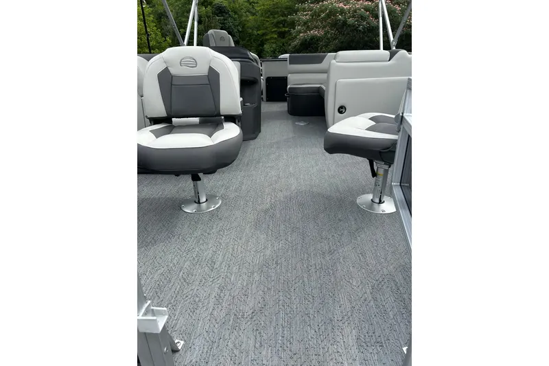 Slide: The Image of 2026 Sun Tracker Fishin' Barge 20 DLX interior with gray seating and carpet. - 2