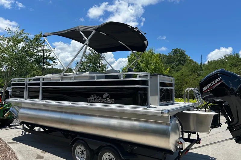 Slide: The Image of 2026 Sun Tracker Fishin' Barge 20 DLX pontoon boat with Mercury engine on trailer. - 4
