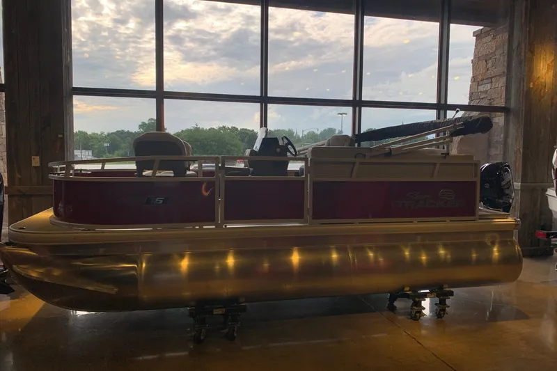 The Image of 2026 Sun Tracker Bass Buggy 16 XL Select pontoon boat displayed indoors. - 0