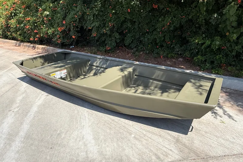 Slide: The Image of 2026 Tracker Grizzly 12 Jon boat on concrete, surrounded by greenery. - 5