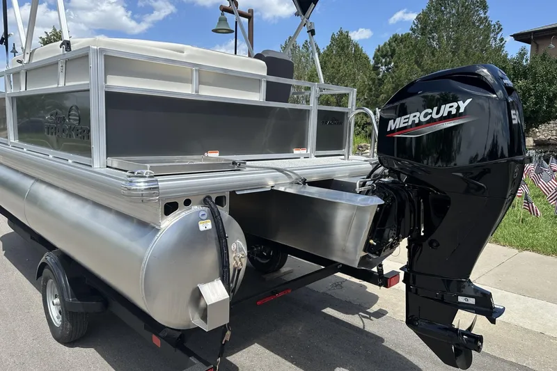 Slide: The Image of 2026 Sun Tracker Bass Buggy 16 XL Select pontoon boat with Mercury outboard motor. - 2