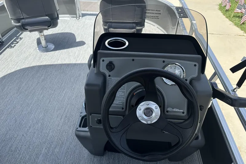 Slide: The Image of 2026 Sun Tracker Bass Buggy 16 XL Select boat dashboard with steering wheel and gauges. - 12
