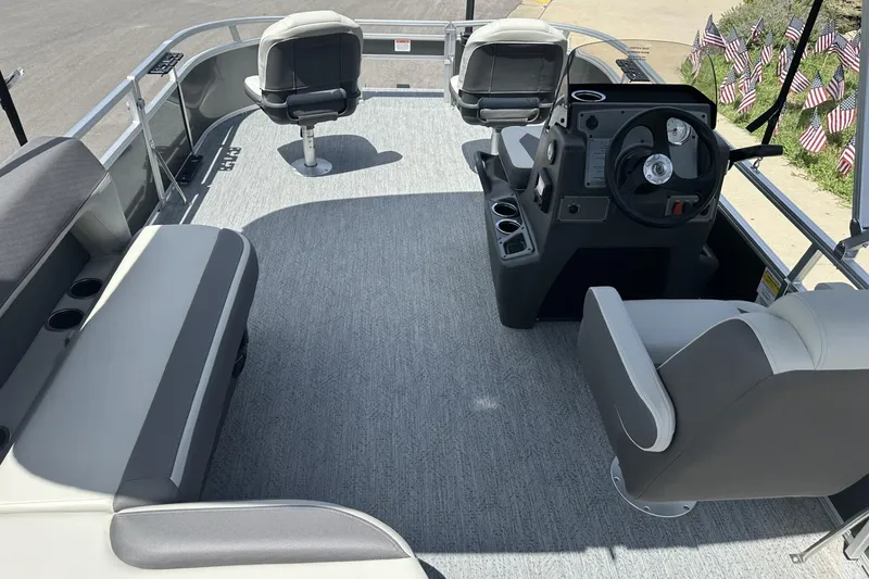 Slide: The Image of 2026 Sun Tracker Bass Buggy 16 XL Select pontoon boat interior with seating and steering console. - 14