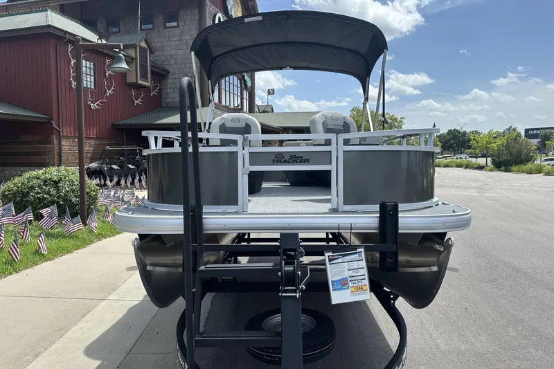 Slide: The Image of 2026 Sun Tracker Bass Buggy 16 XL Select pontoon boat on trailer, outdoor display. - 6