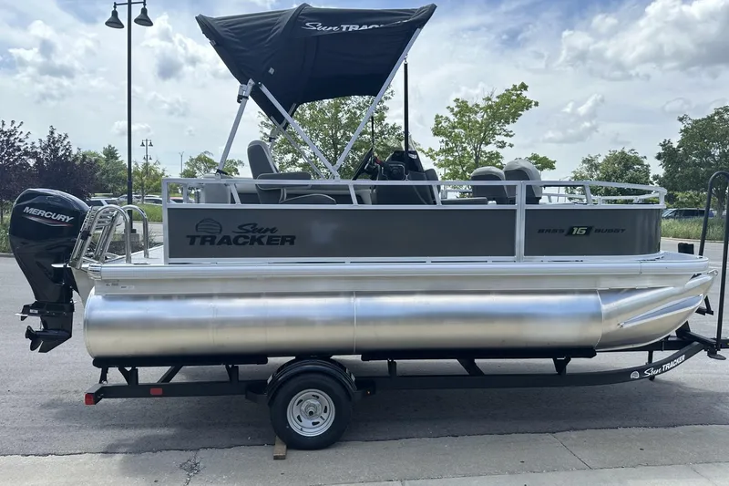 Slide: The Image of 2026 Sun Tracker Bass Buggy 16 XL Select pontoon boat with Mercury outboard motor. - 5