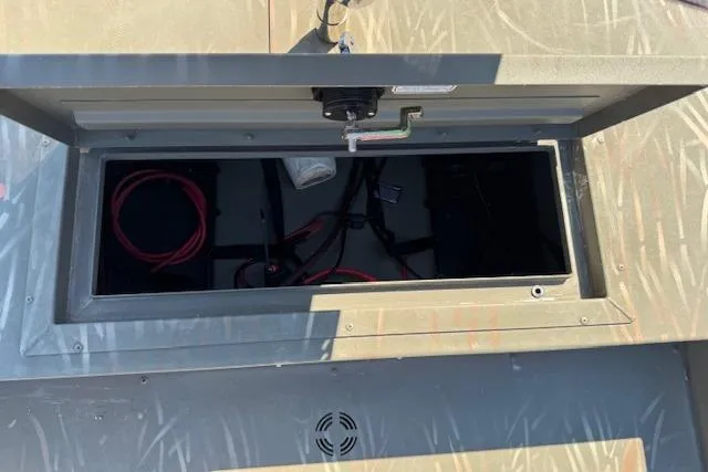 Slide: The Image of Open storage compartment in a 2024 Tracker Grizzly 1754 MVX Jon boat. - 12