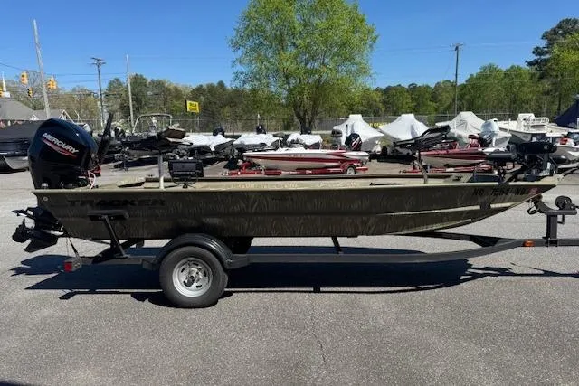 Slide: The Image of 2024 Tracker Grizzly 1754 MVX Jon boat on trailer, parked outdoors. - 3