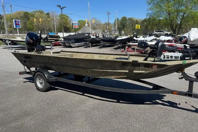 Slide: The Image of 2024 Tracker Grizzly 1754 MVX Jon boat on trailer in outdoor lot. - 4