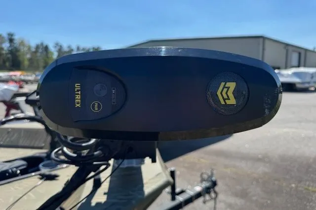 Slide: The Image of 2024 Tracker Grizzly 1754 MVX Jon boat with Ultrex trolling motor in a sunny outdoor setting. - 9