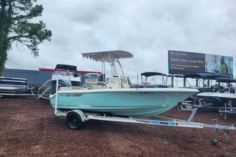 The Image of 2024 Key West 189 FS boat on trailer at dealership, cloudy sky background. - 1