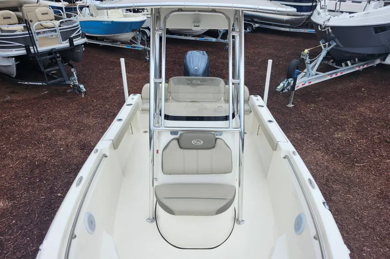 Slide: The Image of 2024 Key West 189 FS boat interior with seating and console, displayed outdoors. - 12