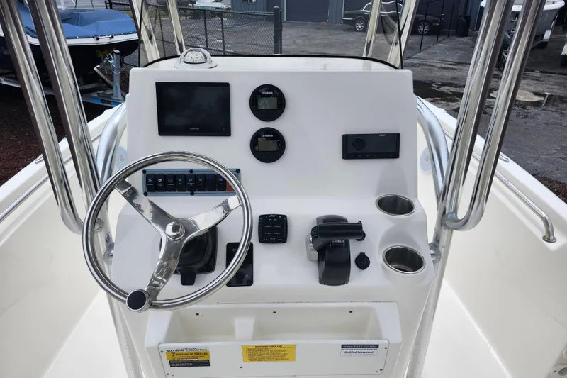 Slide: The Image of 2024 Key West 189 FS boat console with steering wheel, gauges, and controls. - 19