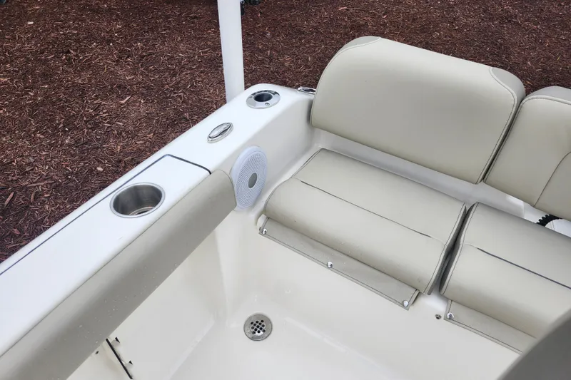 Slide: The Image of 2024 Key West 189 FS boat interior with beige seating and cup holder. - 26