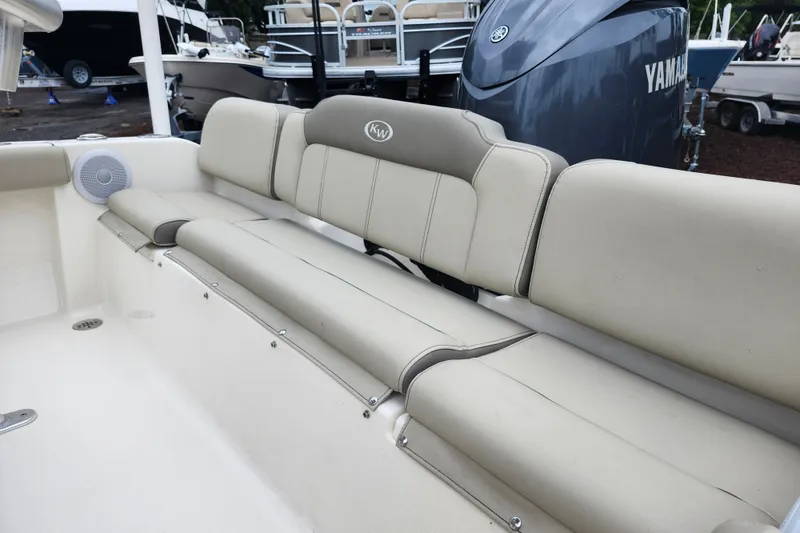 Slide: The Image of 2024 Key West 189 FS boat interior with beige seating and Yamaha engine. - 30