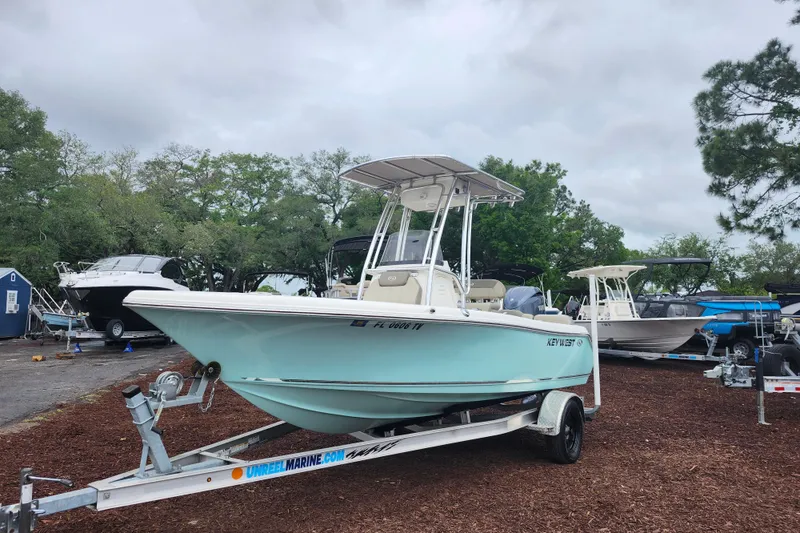 Slide: The Image of 2024 Key West 189 FS boat on trailer, parked outdoors with other boats. - 4