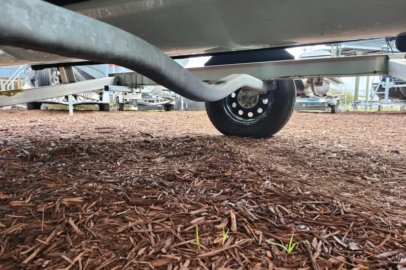 Slide: The Image of Underneath view of a 2024 Key West 189 FS boat trailer on mulch ground. - 41
