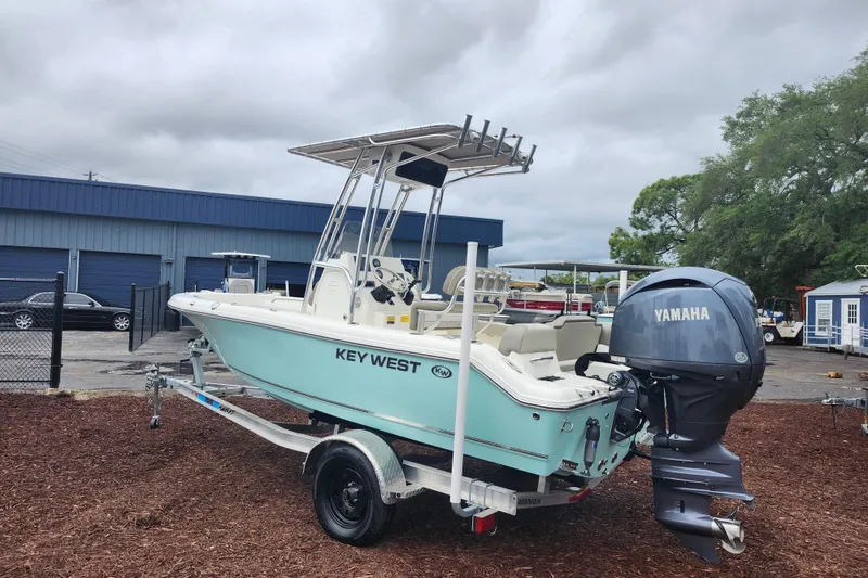 Slide: The Image of 2024 Key West 189 FS boat with Yamaha engine on trailer, parked outdoors. - 6