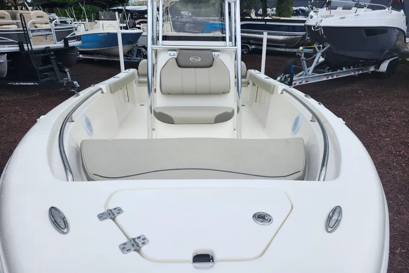 Slide: The Image of 2024 Key West 189 FS boat interior with seating and storage, displayed outdoors. - 9