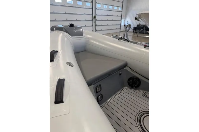 Slide: The Image of 2023 Brig Navigator 610 boat interior with cushioned seating and modern design. - 6
