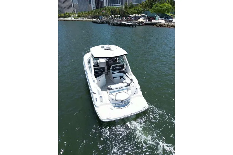 Slide: The Image of 2014 Monterey 320 Sport Yacht cruising near a city waterfront. - 10