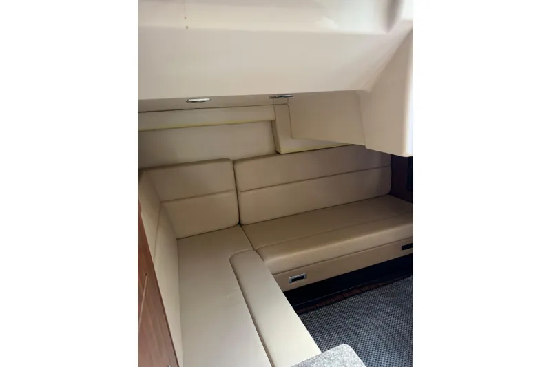 Slide: The Image of Interior cabin of 2014 Monterey 320 Sport Yacht with beige seating. - 14