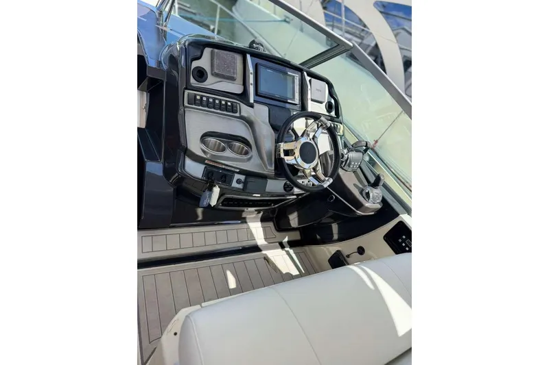 Slide: The Image of Cockpit of 2014 Monterey 320 Sport Yacht with modern controls and steering wheel. - 16
