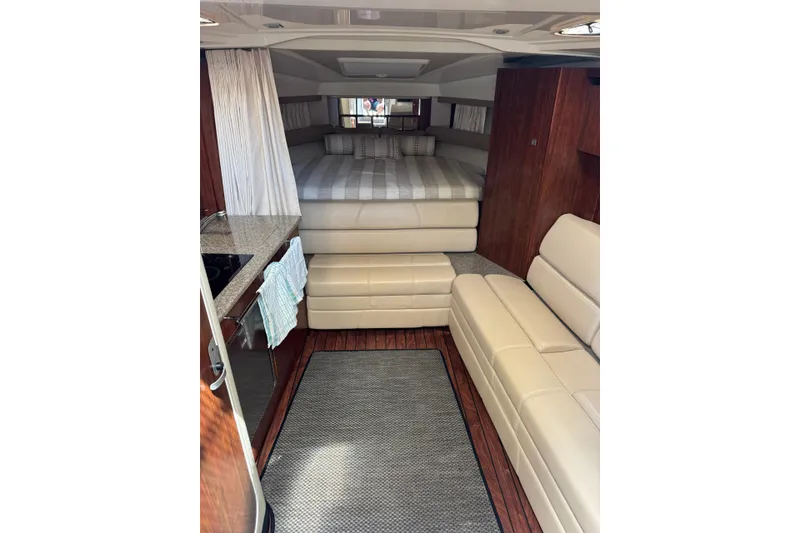 Slide: The Image of Interior of 2014 Monterey 320 Sport Yacht with cozy seating and bed area. - 18