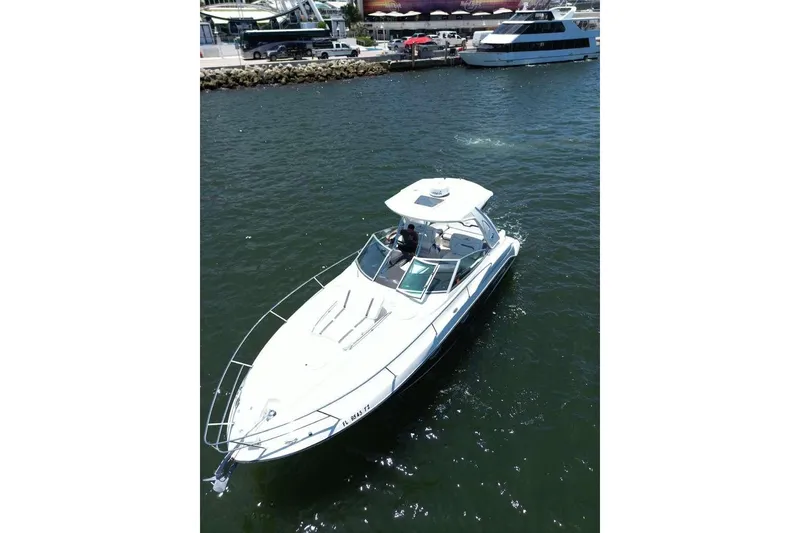 Slide: The Image of 2014 Monterey 320 Sport Yacht cruising in a marina, surrounded by water and other boats. - 5