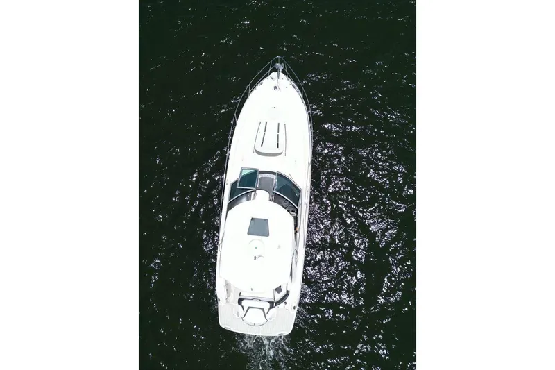 Slide: The Image of Overhead view of a 2014 Monterey 320 Sport Yacht on dark water. - 7