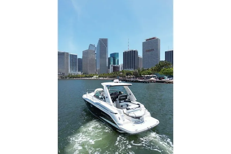 Slide: The Image of 2014 Monterey 320 Sport Yacht cruising near city skyline on a sunny day. - 9