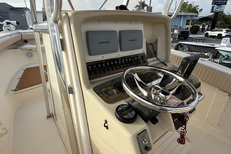 Slide: The Image of 2006 Scout 260 Sportfish boat helm with Garmin displays and steering wheel. - 18