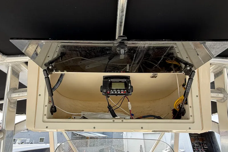 Slide: The Image of Open electronics compartment on 2006 Scout 260 Sportfish boat, featuring mounted radio equipment. - 19