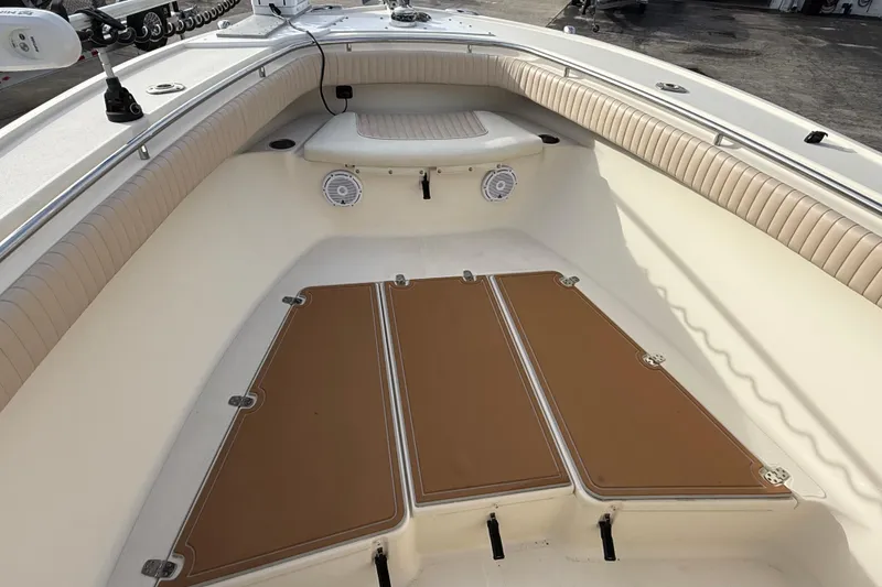 Slide: The Image of 2006 Scout 260 Sportfish boat interior with cushioned seating and storage compartments. - 21