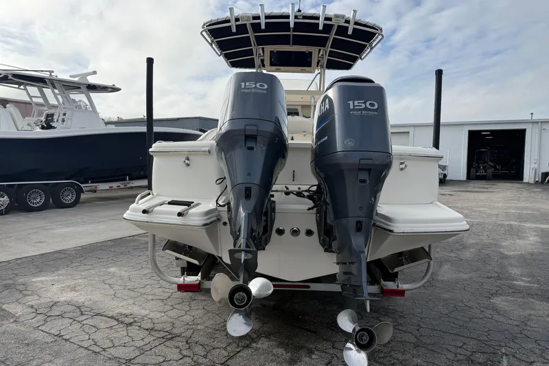 Slide: The Image of 2006 Scout 260 Sportfish boat with dual Yamaha 150 engines, parked outdoors. - 6