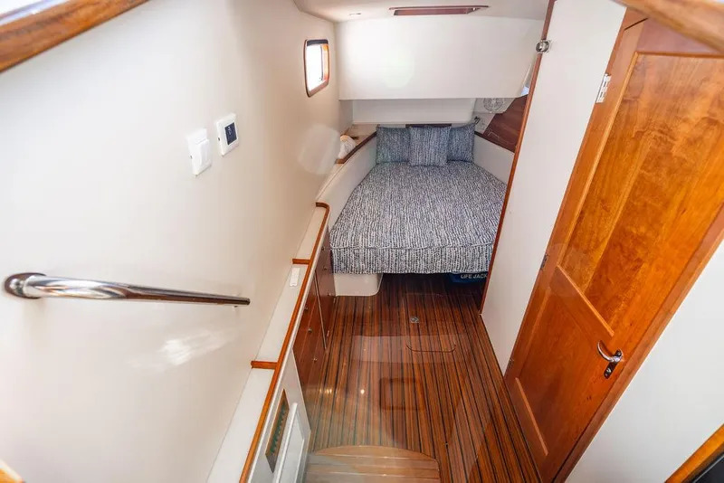 Slide: The Image of 2024 MJM 4 boat cabin with wooden flooring and cozy bed. - 10