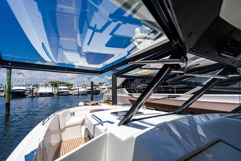 Slide: The Image of 2024 MJM 4 Yacht with open roof at the marina. - 12