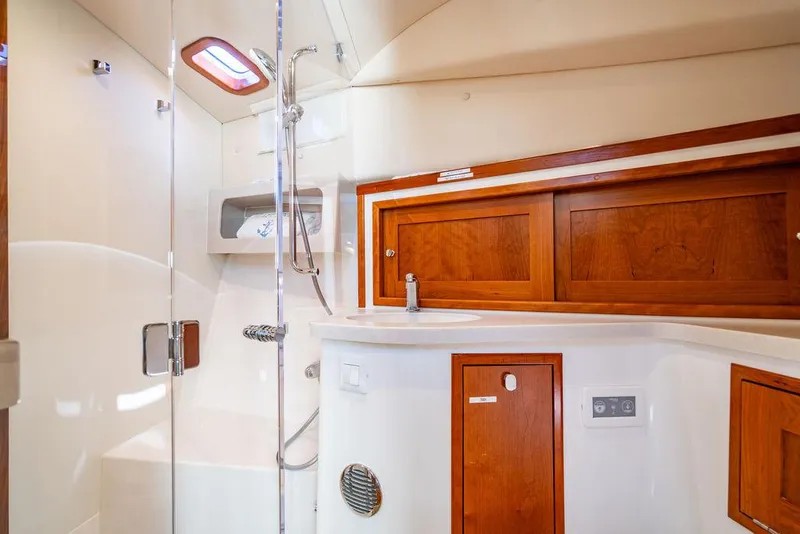 Slide: The Image of 2024 MJM 4 yacht bathroom with wooden cabinets and modern shower. - 21