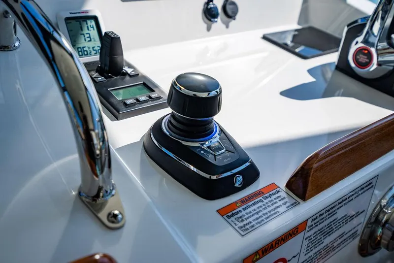 Slide: The Image of 2024 MJM 4 boat control panel with joystick and instrument display. - 42