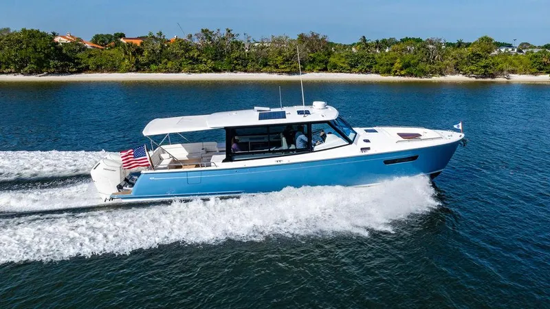 Slide: The Image of 2024 MJM 4 yacht cruising on a serene waterway, showcasing sleek design and performance. - 59