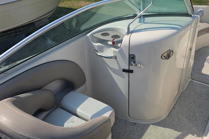 Slide: The Image of 2003 Sea Ray 220 Sundeck interior with seating and console details. - 11