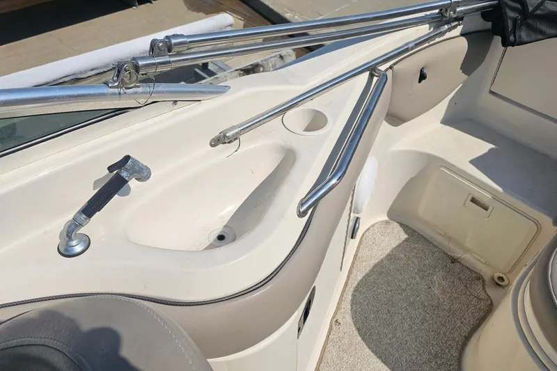 Slide: The Image of Interior view of a 2003 Sea Ray 220 Sundeck boat, featuring seating and railings. - 17