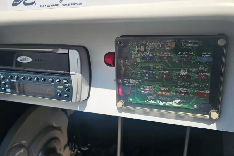 Slide: The Image of 2003 Sea Ray 220 Sundeck dashboard with Clarion stereo and fuse panel. - 18