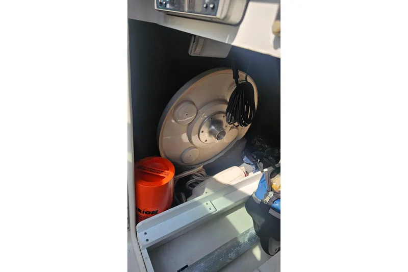 Slide: The Image of Storage compartment of 2003 Sea Ray 220 Sundeck with equipment and accessories. - 19